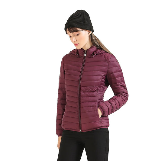 A winter coat for women that is lightweight and extremely warm with a hat in a selection of colors